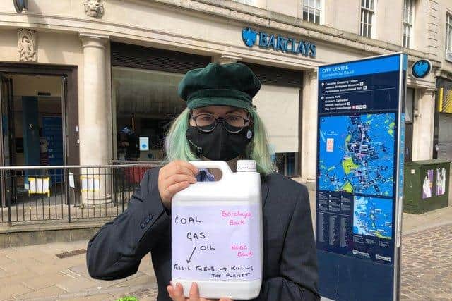 Extinction Rebellion activist Selma Heimedinger before dumping fake oil into a children's paddling pool in front of the Barclays branch in Commercial Road in April. Picture: Richard Lemmer