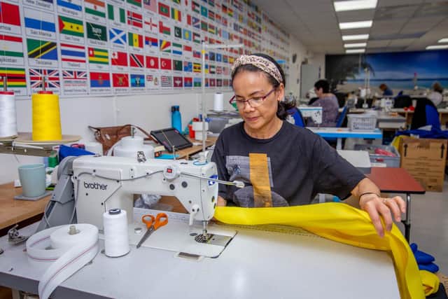 Truengjai Hydy putting a flag together in the Hampshire Flag Company workshop.
Picture: Habibur Rahman