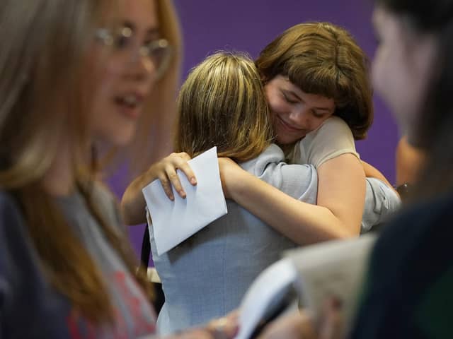 Students congratulate each other receiving their GCSE results. Photo: PA