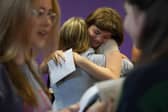 Students congratulate each other receiving their GCSE results. Photo: PA