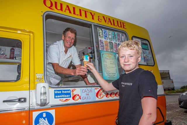 Graham Penrose giving Bradley Tollhurst 12 an ice cream at Portsdown Hill, Portsmouth on July 27, 2021

Picture: Habibur Rahman