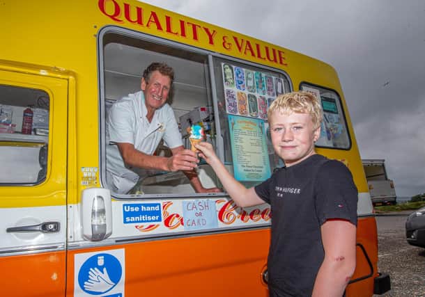 Graham Penrose giving Bradley Tollhurst 12 an ice cream at Portsdown Hill, Portsmouth on July 27, 2021

Picture: Habibur Rahman
