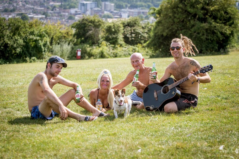 Hot weather on Portsdown Hill on the 23rd July 2019.
Soaking up the sun, Jason Cowlishaw, Joelene Grant, Michael Manton and his son, Oliver Manton with Brodie the dog.  
Picture: Habibur Rahman