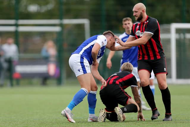 Keiran Hammond, left, and Jim Duffin clash during Denmead's HPL Cup loss to Fleetlands at Front Lawn. Picture: Chris Moorhouse