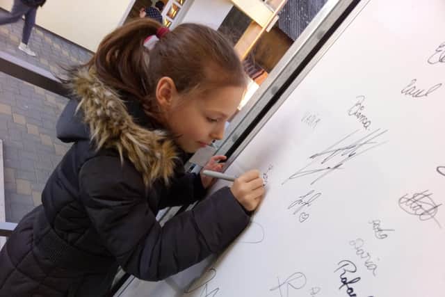 One of the refugees signing the truck