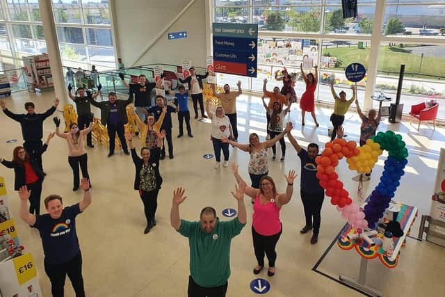 Fratton Tesco held a fundraiser for the NHS and two-year-old George McGowan, who boosted the total by selling toys, was invited to hand the cheque over to Queen Alexandra Hospital. Pictured: Staff in bright clothes for the fundraiser