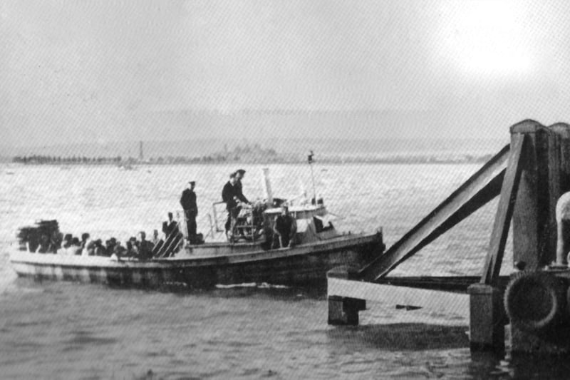 The Portsmouth to Hayling ferry arrives at Hayling. No date for this photograph, but it is an unchanging scene across Langstone Harbour.