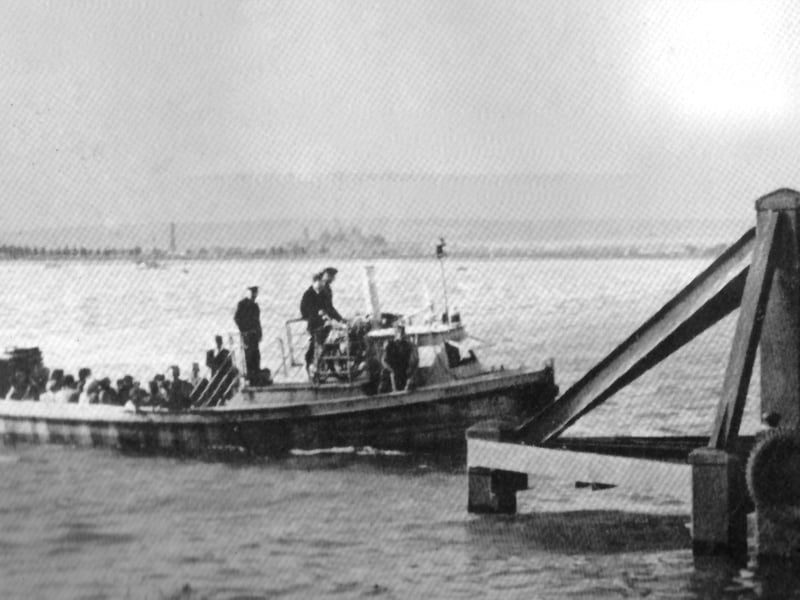 The Portsmouth to Hayling ferry arrives at Hayling. No date for this photograph, but it is an unchanging scene across Langstone Harbour.