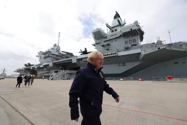 Prime minister Boris Johnson pictured strutting along Princess Royal Jetty during his trip to see HMS Queen Elizabeth.  Picture by Andrew Parsons / No 10 Downing Street