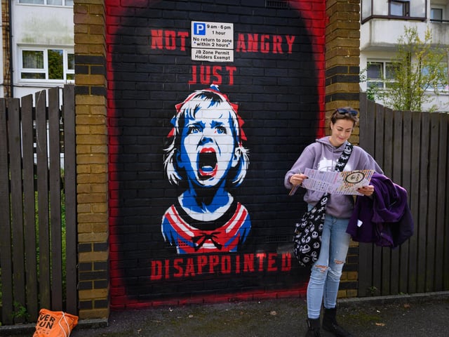 Pictured is: Ella Jones checks out the Look UP map as she stands in front of artwork in Church Road Picture: Keith Woodland (140921-12)