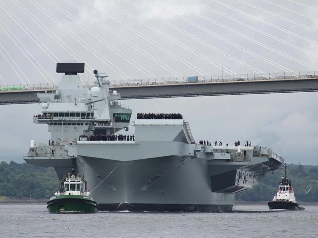 HMS Queen Elizabeth leaving Rosyth in Fife, Scotland, and sailing under the Forth bridge. She is due to return home to Portsmouth on July 30.