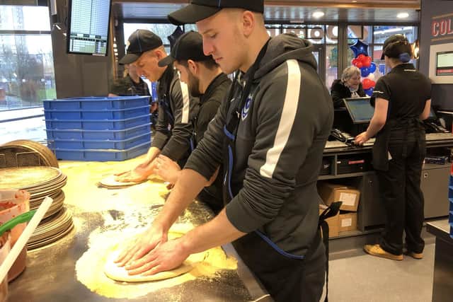 The new Domino's Pizza store that has opened in Winston Churchill Avenue in Portsmouth. Portsmouth FC players Craig MacGillivray and Bryn Morris got to go behind the scenes and learn how to make a pizza. 