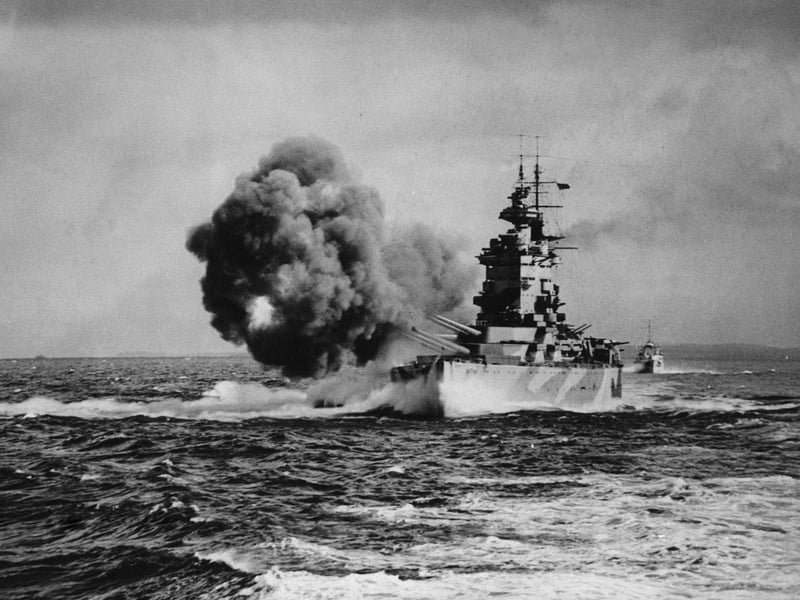 The Royal Navy Nelson-class battleship HMS Nelson, named in honour of Horatio Nelson, 1st Viscount Nelson the victor at the Battle of Trafalgar, fires a full broadside with her nine16-inch (406 mm) guns known as Happy, Grumpy, Sneezy, Dopey, Sleepy, Bashful, Doc, Mickey and Minnie after the characters in the film Snow White whilst on operations in the Mediterranean as part of Force H on 1 August 1942 in the Mediterranean near Gibralter.  (Photo by Keystone/Hulton Archive/Getty Images).