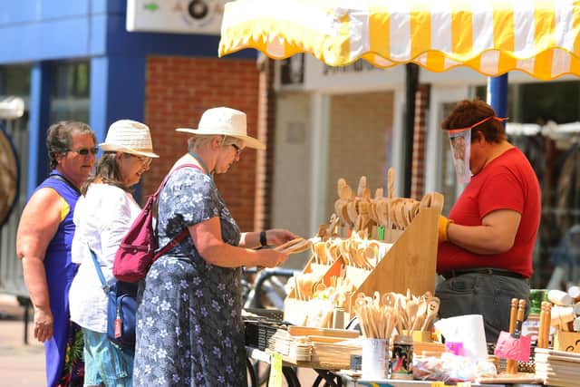 Gosport Market reopened in the High Street on Tuesday, June 2. 

Pictured is: (right) Grzegorz Zurek serving on his stall.

Picture: Sarah Standing (020620-3766)