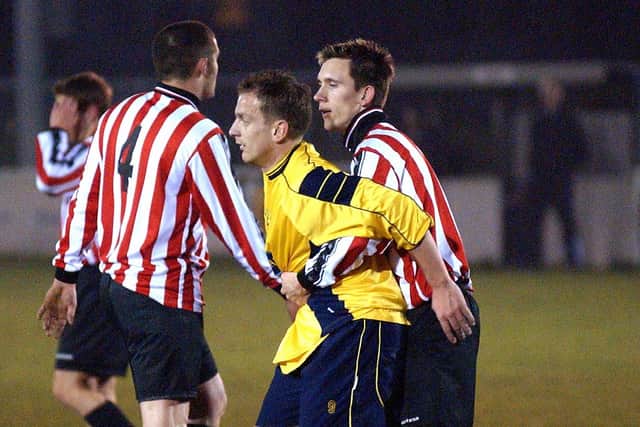 Lee Mould is closely marked by a Whitchurch defender. Picture: Mick Young.