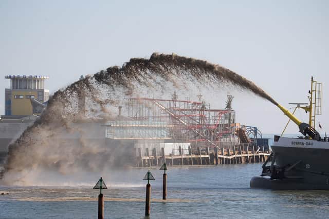 The dredger vessel Sospan Dau sprays gravel onto the foreshore of Portsmouth seafront to develop a temporary working platform during the first stages of a £100 million sea defence scheme. Photo: Andrew Matthews/PA Wire