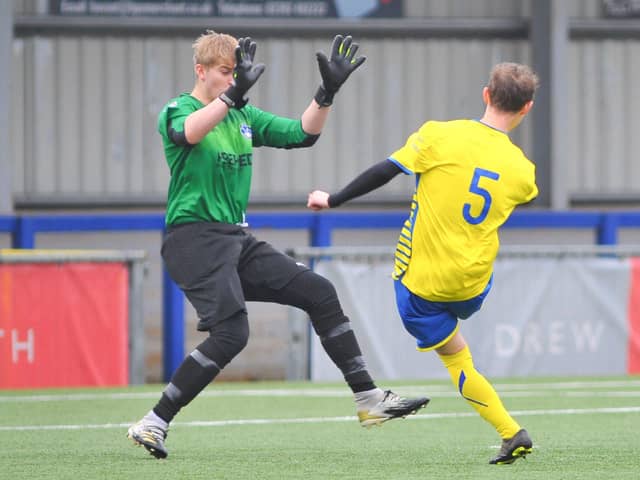 Steve Hawley lobs Clanfield keeper Ash Wright - the ball rebounding off a post and in off Wright for Locks Heath's second goal. Picture: Martyn White