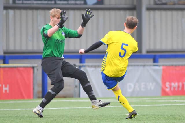 Steve Hawley lobs Clanfield keeper Ash Wright - the ball rebounding off a post and in off Wright for Locks Heath's second goal. Picture: Martyn White