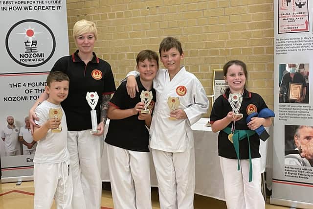 The students who have been awarded with trophies after being graded