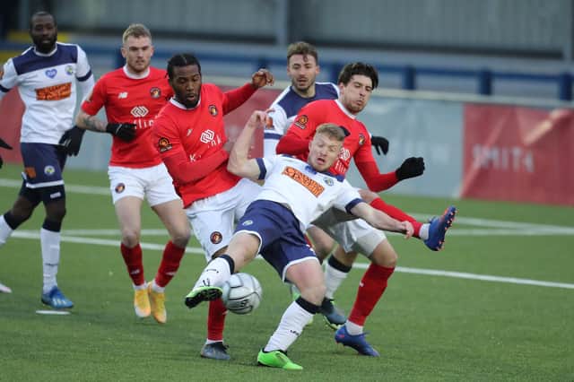 Tommy Wright is closely watched by Ebbsfleet defenders. Photo by Dave Haines