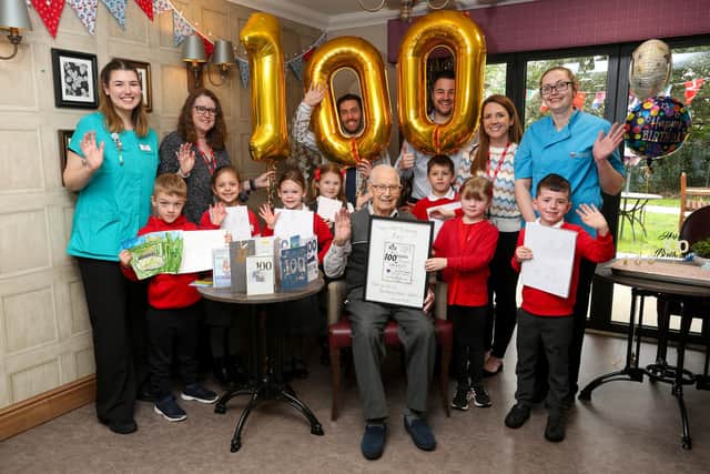 Resident Ray Parsley celebrates his 100th birthday with a visit from pupils at nearby Sarisbury Infant School