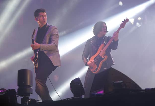 Alex Turner (left) and Nick O'Malley  of the Artic Monkeys performing on the Pyramid Stage, during the first performance day of the Glastonbury 2013 Festival of Contemporary Performing Arts at Pilton Farm, Somerset. Photo: Yui Mok/PA Wire