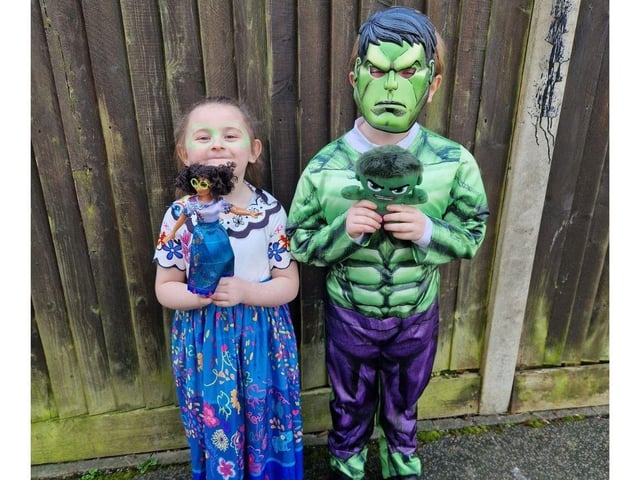 Elsie has dressed up as Mirabel from Encanto and Frank has dressed up as the Hulk.