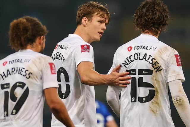 Sean Raggett, centre, after his goal last weekend. Picture: Nigel Keene