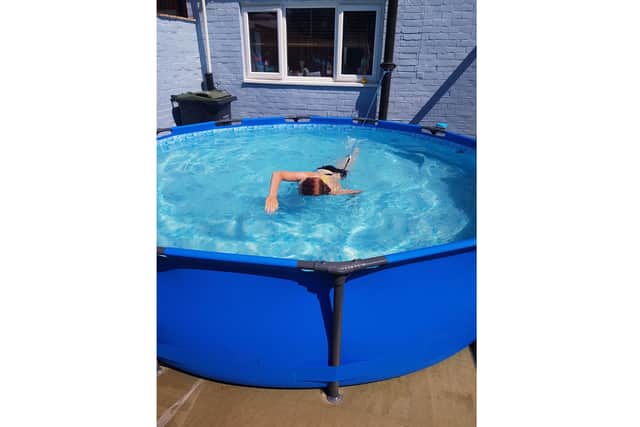 Rosie Deem, 14 from Gosport, is taking on a swimming, cycling and running challenge to raise funds for Cancer Research UK. Pictured: Rosie  swimming in her 12ft back garden pool