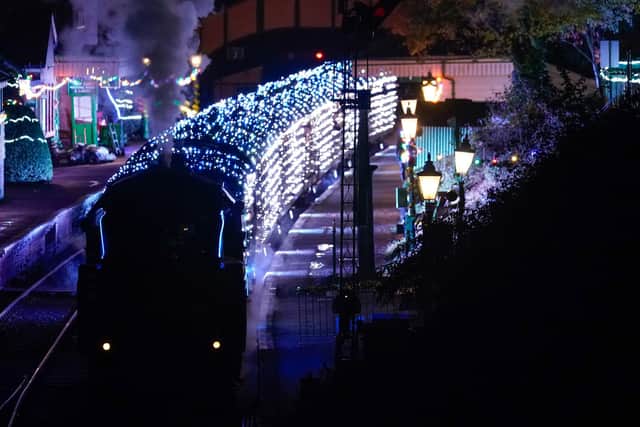 The BR Standard Class no. 70167 leaves Ropley station as it pulls a Steam Illuminations train, a light show on and in a steam train, consisting of thousands of fully controllable colour mixing LED lights, on the Watercress Line in Hampshire, which forms part of their Christmas programme of events. Picture date: Friday November 12, 2021. PA Photo. Photo credit should read: Andrew Matthews/PA Wire