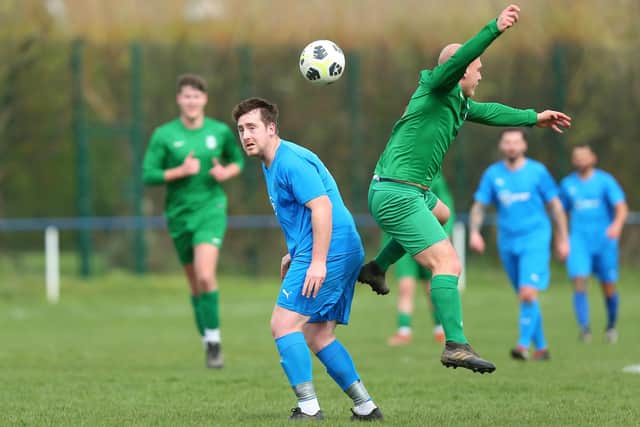 Paulsgrove's Jake Pepall (blue) v Overton.  Picture: Chris Moorhouse