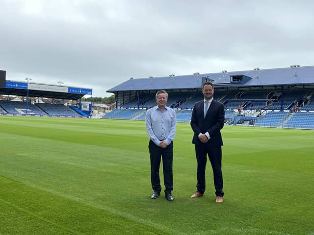 Andrew Cullen, Chief Executive of Portsmouth FC with Stephen Morgan MP on the pitch at Fratton Park