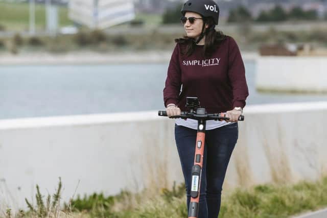 A woman on a Voi e-scooter in Portsmouth