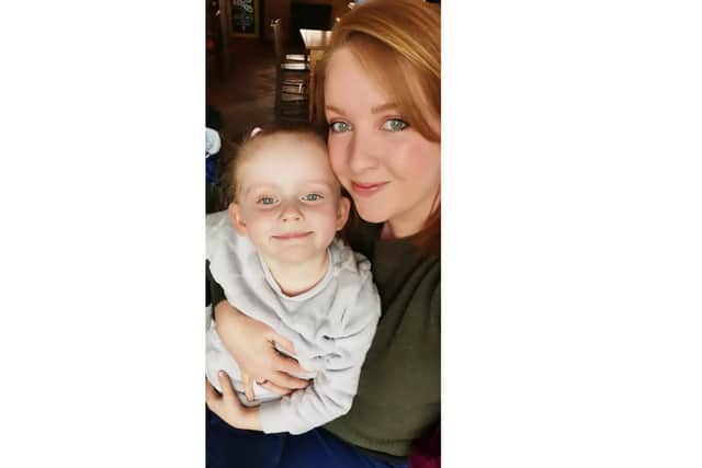 Mum and daughter duo Holly and Elsie Mitchell, four, have been putting out 'yarn bomb' creations to cheer up children heading to St John's CE Primary School in Gosport. Pictured: Elsie and Holly