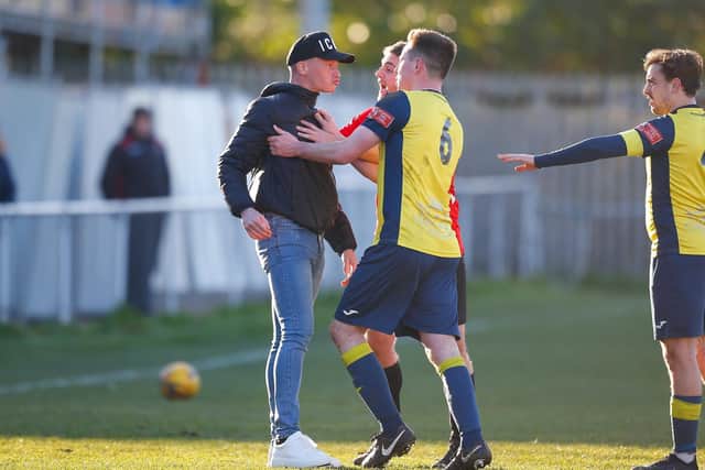 A Fareham Town spectator confronts Moneyfields' Tom Cain. Picture: Dave Bodymore.