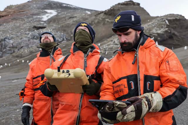 Sailors from HMS Protector pictured supporting the research into the penguin population