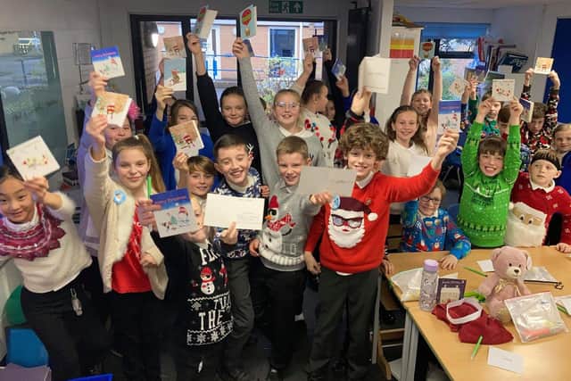 Thousands of cards flooded in to a festive appeal from Asda stores. Pictured: Gomer Junior School pupils with their kind cards