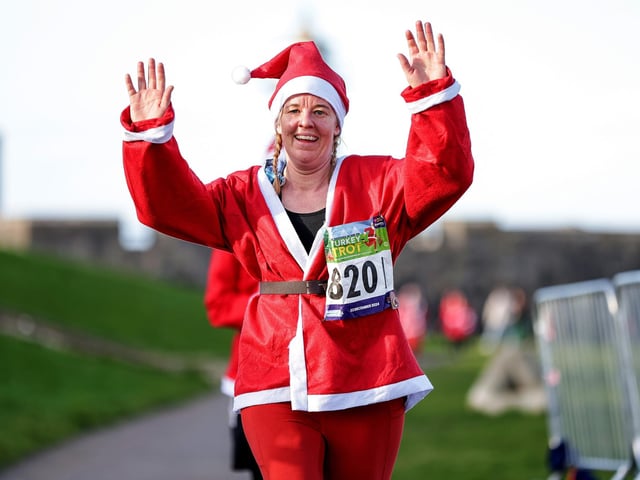 A festive runner on the Turkey Trot nears the finish line. Picture: Chris  Moorhouse (221224-82)