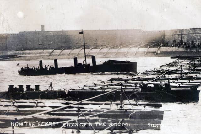 HMS Ferret tests the boom defence across the entrance to Portsmouth Harbour in 1909.