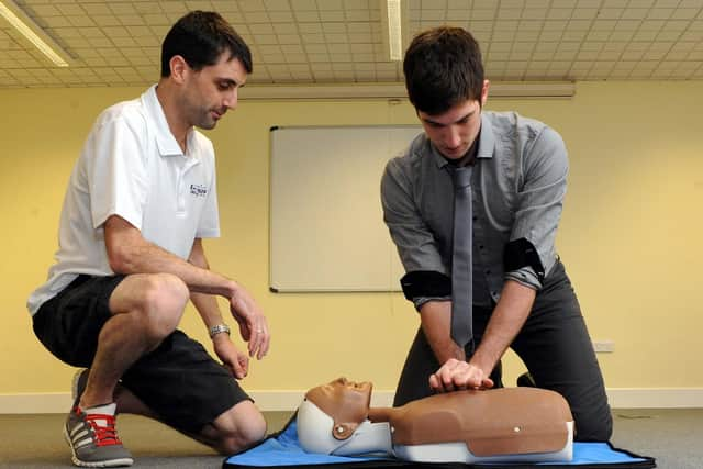 Defence correspondent Tom Cotterill pictured during a first aid event at the Littlehampton Swimming and Sports Centre with coach Mike Mole in 2013.