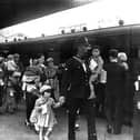 Portsmouth policeman with evacuees. The News PP292