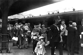 Portsmouth policeman with evacuees. The News PP292