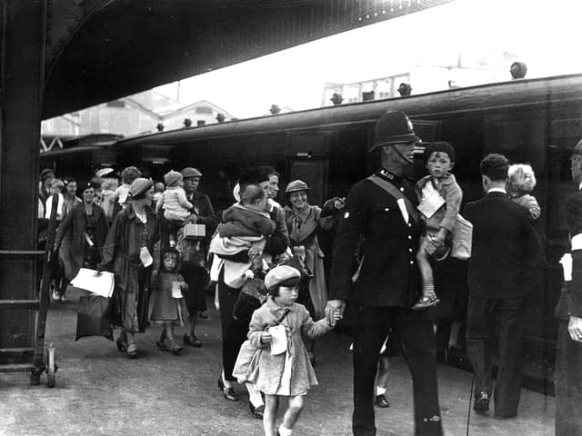 Portsmouth policeman with evacuees. The News PP292