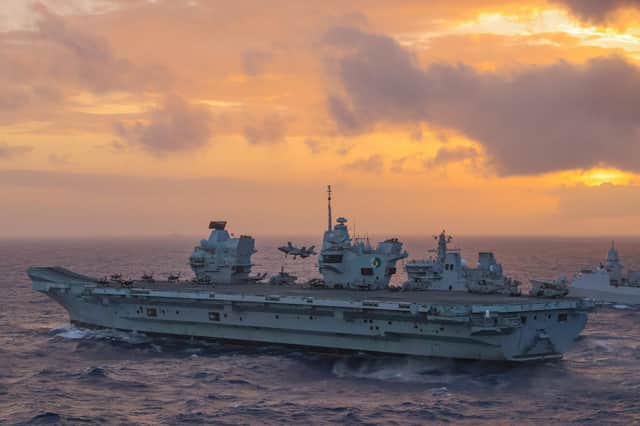 Pictured: An F-35B jet lands back on HMS Queen Elizabeth whilst she conducts a double replenishment with RFA Tidespring and HNLMS Evertsen.