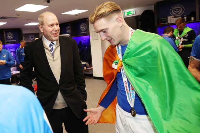 Ronan Curtis, donning the Irish tricolour, speaks to owner Michael Eisner after Pompey's Checkatrade Trophy triumph. Picture: Joe Pepler