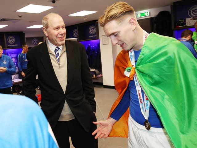 Ronan Curtis, donning the Irish tricolour, speaks to owner Michael Eisner after Pompey's Checkatrade Trophy triumph. Picture: Joe Pepler