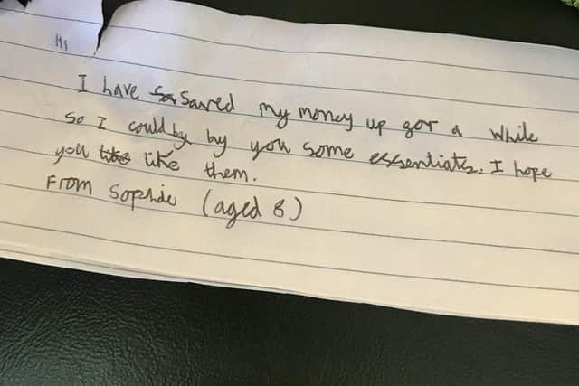 A young girl named Sophie, 8, saved up her pocket money to buy gifts for people living in the homeless pods in Gosport. Pictured: The note from Sophie which was included in each bag