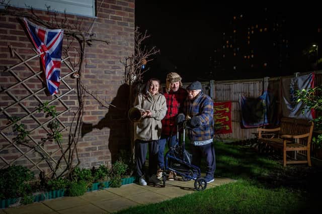 Joanne White, her partner David, and her father, 98-year-old Gerald John Castleton, in their garden in Grosvenor Street, Portsmouth, celebrating Clap for Heroes. Picture: Habibur Rahman