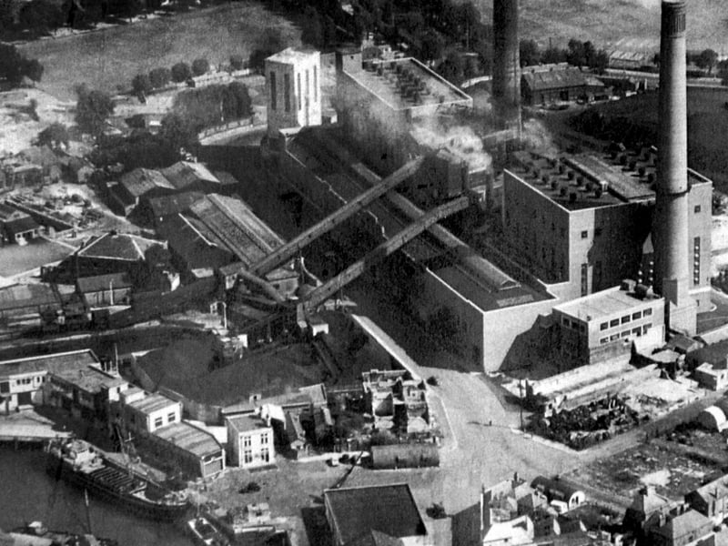 Old Portsmouth Power Station circa 1948. To the bottom left is the Camber with the cola hoppers of Whites the coal merchant. Unloading at the wharf is a large collier with three barges alongside. At the pointed end of the coal wharves can just be seen the Bridge Tavern which is dwarfed by them. Above the Bridge Tavern is the lock for the coal barges that brought in coal for the power station.
The covered travellators for taking the coal up and over Gunwharf Road can be seen. Above the lock are the buildings of HMS Vernon. To the bottom right can be seen Oyster Street which at this time passed into White Hart Lane and since these times a block of flats have been built over it.
St Thomas Street passes behind the cathedral with many of the buildings just bomb sites. The bank now a residential building on the corner of Highbury Street can be Cleary seen.
The east end of St Thomas's Street and Warblington Street leaading into St Georges Road close by Landport Gate are both bomb sites.
To the top right hand corner can be seen the United Services cricket ground where, up until the Rose Bowl was built, Hampshire played first class cricket.
Above the power station chimneys the railway line from the Harbour station to Portsmouth & Southsea High Level can be seen running along its tree lined route.