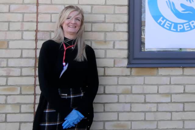 Portsmouth player Christian Burgess visited Hayling Island to help the staff and coaches from Heart of Hayling Boxing Academy deliver prescriptions to people in the community. Pictured: Wendy Ball, who set up the Hayling Helpers, with Christian Burgess